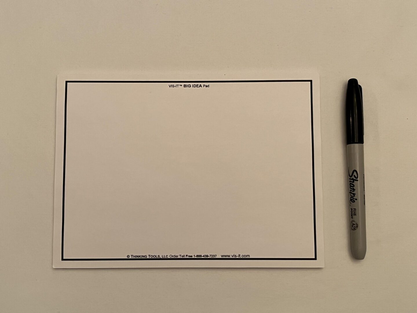 A WHITE VIS-IT™ Post-it Big Idea Pad 8x6 in. (50 sheets) with a black marker on it.