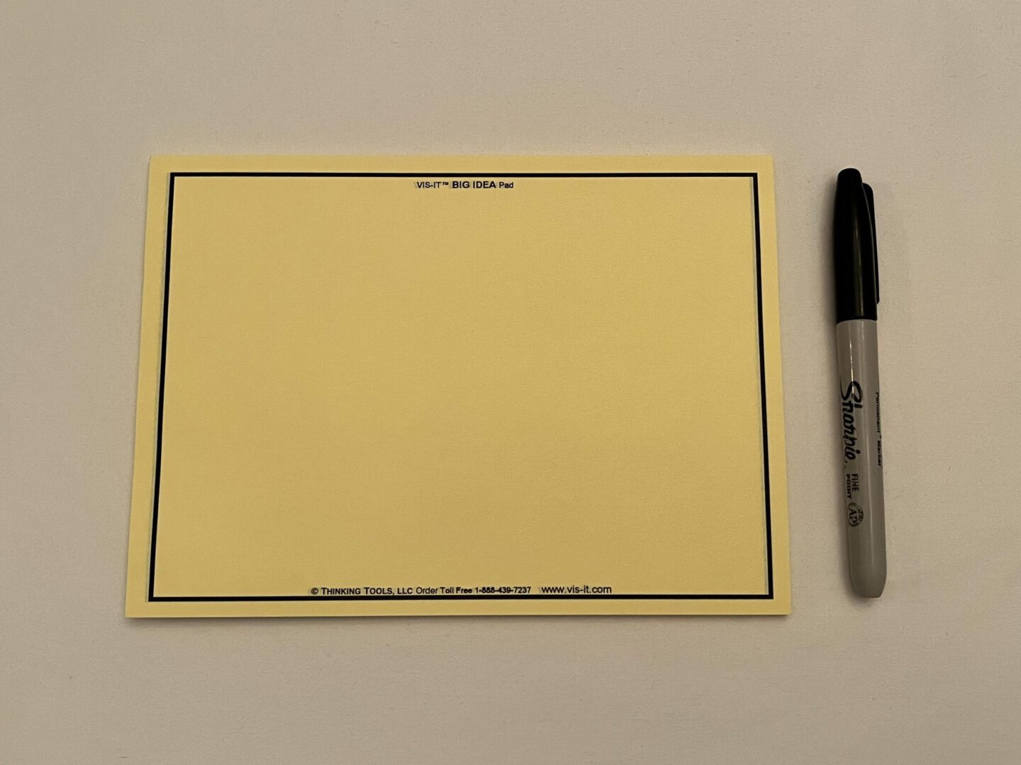 A YELLOW VIS-IT™ Big Idea Pad 8x6 in. (50 sheets) with a marker and a pen.