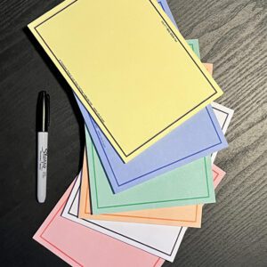 A stack of SIX-COLOR Set of VIS-IT™ 8x6 in. Big Idea Pads (300 sheets total) and a marker on a table.
