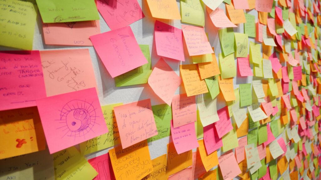 A wall covered in post it notes.
