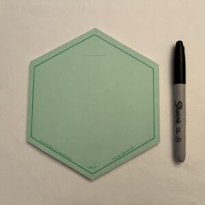 The GREEN VIS-IT™ Hexagon Pad 6x6 in. (50 sheets) with a marker on it.