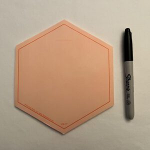 An ORANGE VIS-IT™ Hexagon Pad 6x6 in. (50 sheets) with a marker and a pen next to it.