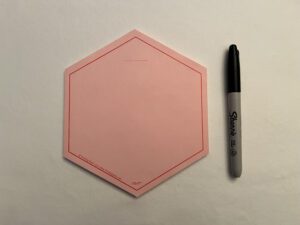 A RED VIS-IT™ Hexagon Pad 6x6 in. (50 sheets) next to a marker.
