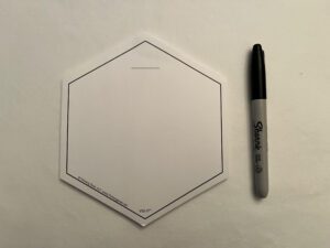 A WHITE VIS-IT™ Hexagon Pad 6x6 in. (50 sheets) with a marker next to it.